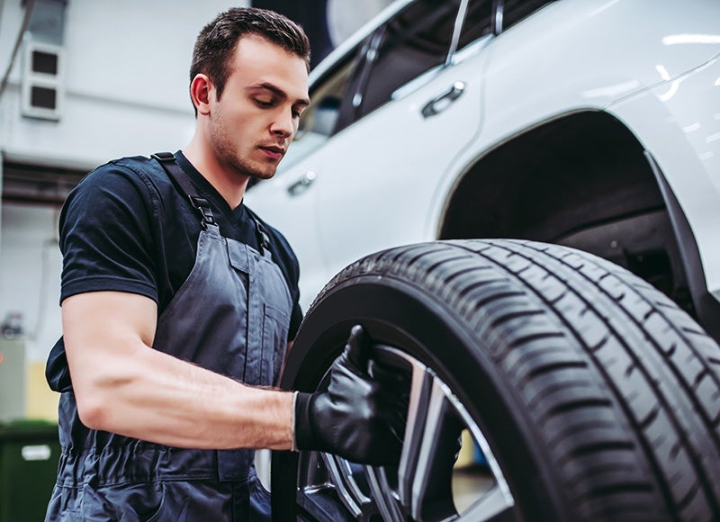 A mechanic fitting a tire